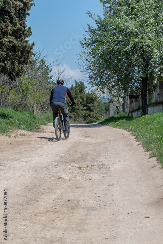 Wallpaper Mural A man riding a bicycle on the driveway in the park. Torontodigital.ca
