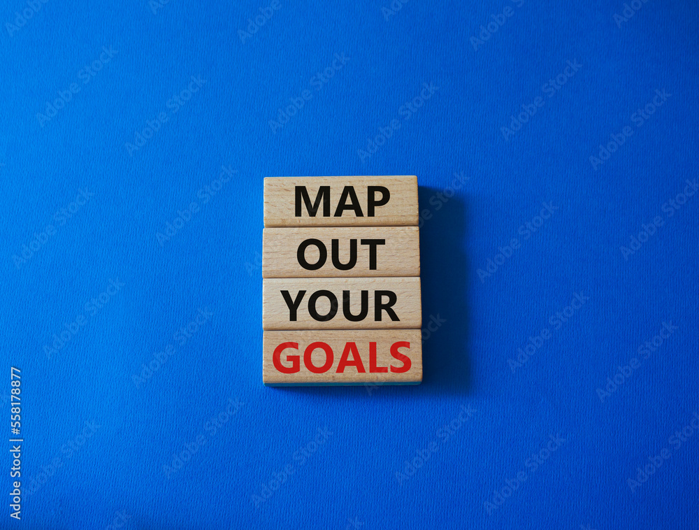 Goals symbol. Wooden blocks with words 'Map out your goals'. Beautiful blue background. Business and 'Map out your goals' concept. Copy space. Goals symbol. Wooden blocks with words 'Map out your goals'. Beautiful blue background. Business and 'Map out your goals' concept. Copy space.