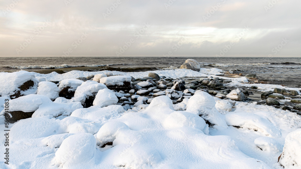 different ice formations on rocks on the seashore, ice texture, wind, water and ice working together