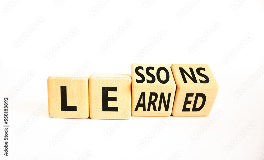 Lessons to learn symbol. Concept word Lessons learn on wooden cubes. Beautiful white table white background. Business education and lessons to learn concept. Copy space.