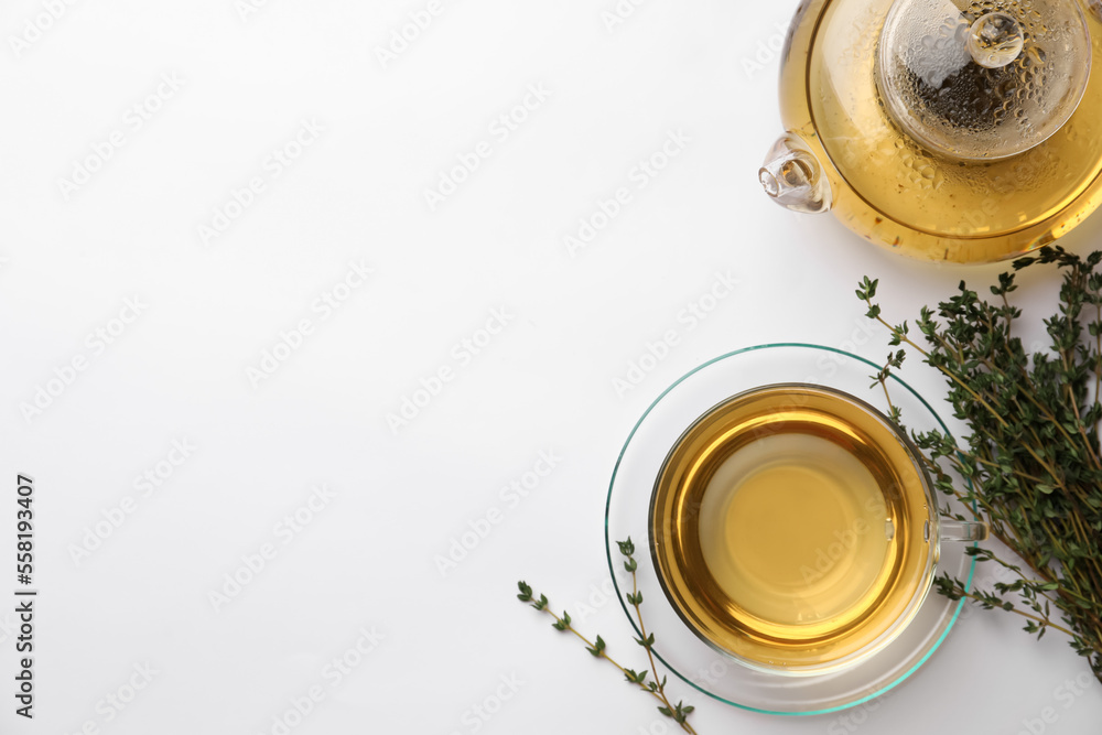 Aromatic herbal tea with thyme on white table, flat lay. Space for text Aromatic herbal tea with thyme on white table, flat lay. Space for text