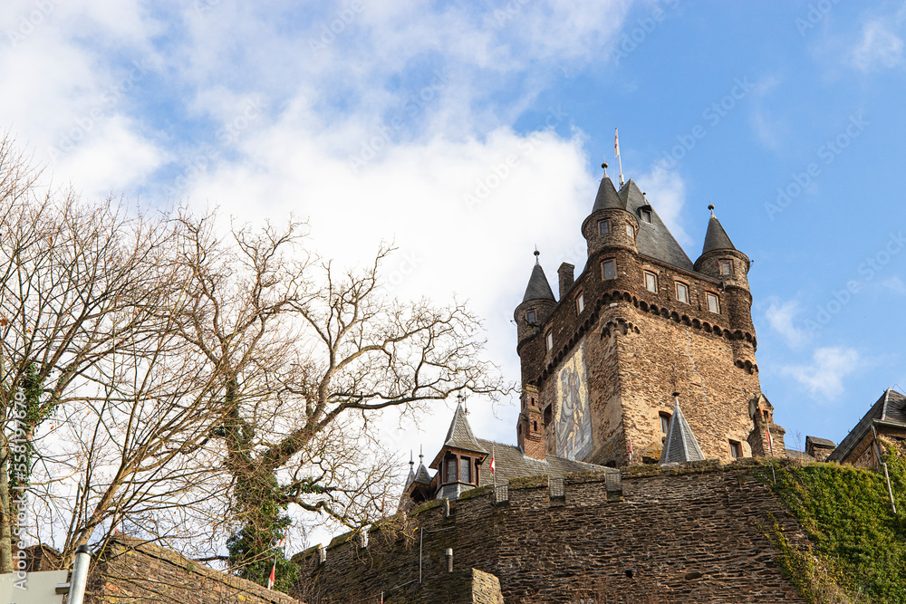 Reichsburg Castle in Cochem over a vineyard in Moselle valley winter, Germany