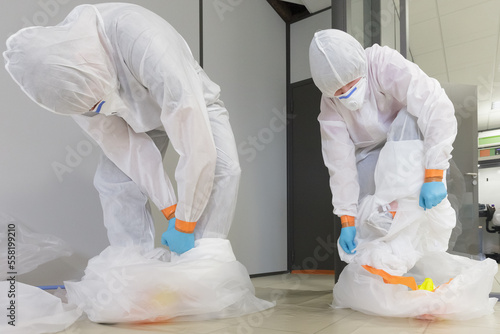 Принти на полотні Operators in type 5/6 hazmat suits performing decontamination procedure, after a