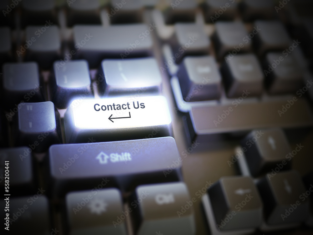 A glowing bright 'contact us' button, key, message on the keyboard. Customer service concept. Internet or online contact for services and businesses. A glowing bright 'contact us' button, key, message on the keyboard. Customer service concept. Internet or online contact for services and businesses.