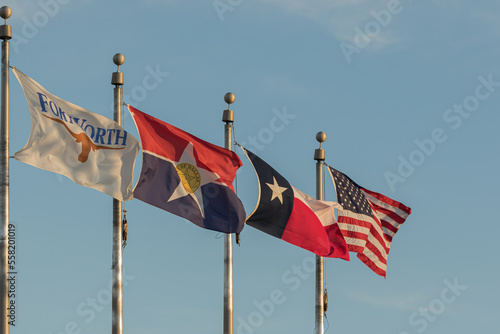Four flags flying at Founders Plaza at Dallas Fort Worth International Airport.