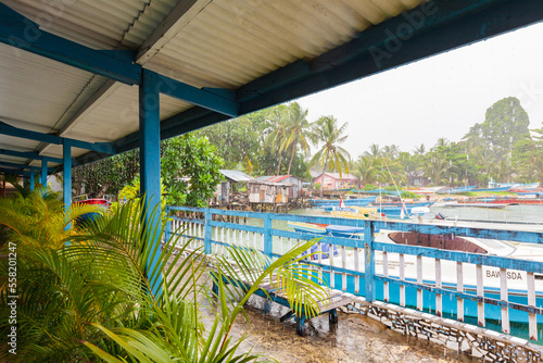 BIAK, WEST PAPUA, INDONESIA - August 2010: colorful veranda lounge of cheap but comfortable backpacker guesthouse, with heavy rain outside