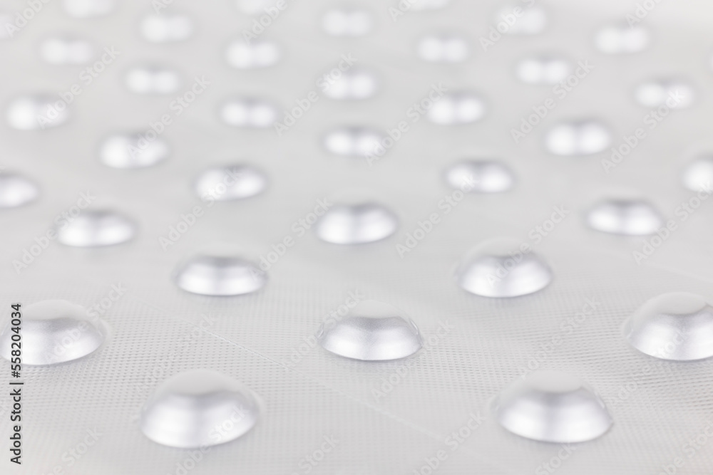 Background image: Pills in an aluminum blister pack. Medicines for treatment.