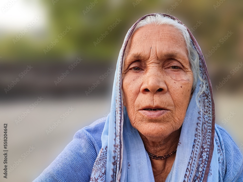 Old lady woman of the rural area of India, smiling, mother, nanny, and grandmother, people live in the village of the India and indian culture Old lady woman of the rural area of India, smiling, mother, nanny, and grandmother, people live in the village of the India and indian culture