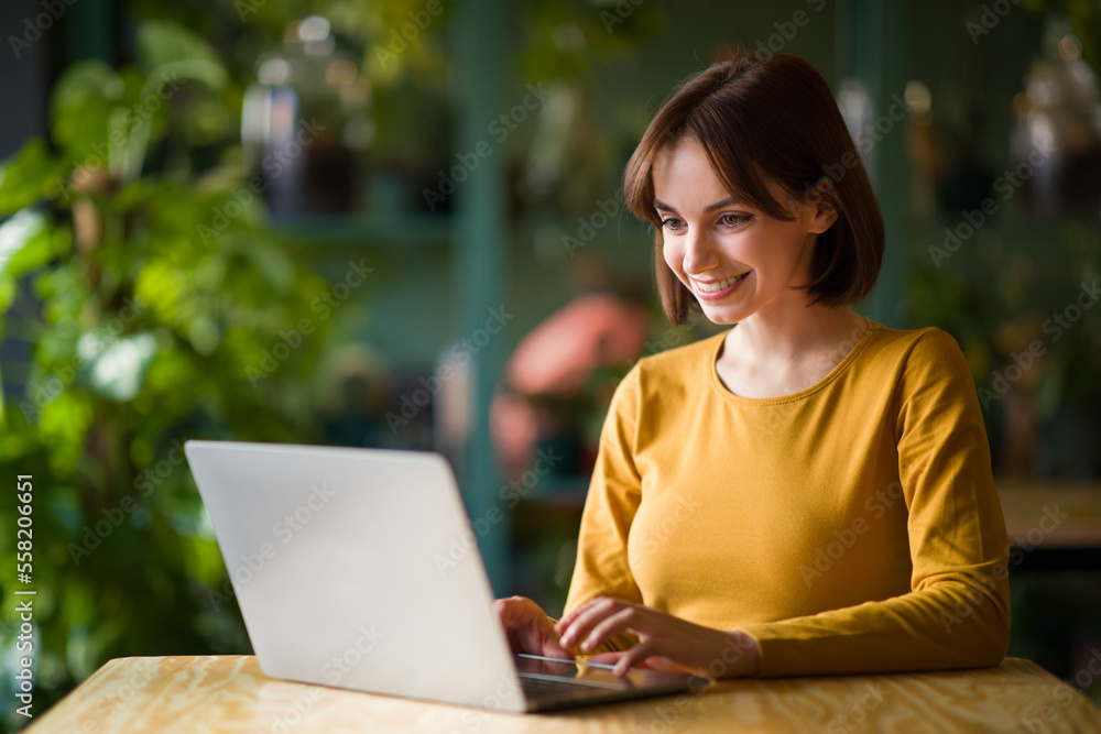 Young woman working on laptop while sitting at cafe Young woman working on laptop while sitting at cafe