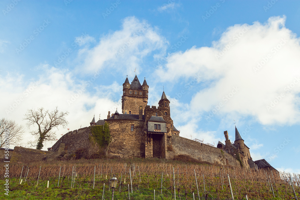 Fototapeta premium Reichsburg Castle is a high-altitude castle on mountain cone over a vineyard in the German town of Cochem on the Moselle, winter landscape