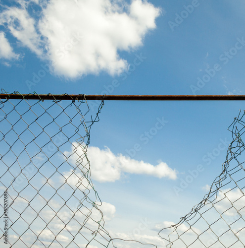 Broken metal mesh fence