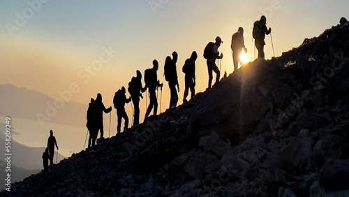 group of professional mountaineers hiking to the summit