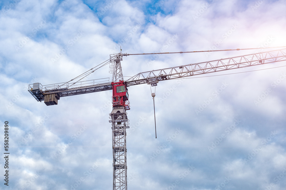 Construction Tower Crane against a blue sky background. High lifting tower crane. The concept of building and construction. Construction of urban structure. Construction Tower Crane against a blue sky background. High lifting tower crane. The concept of building and construction. Construction of urban structure.