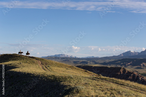 Two cowboys looking out over the valley.