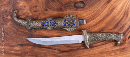 Fotografiet turkish dagger on wooden background