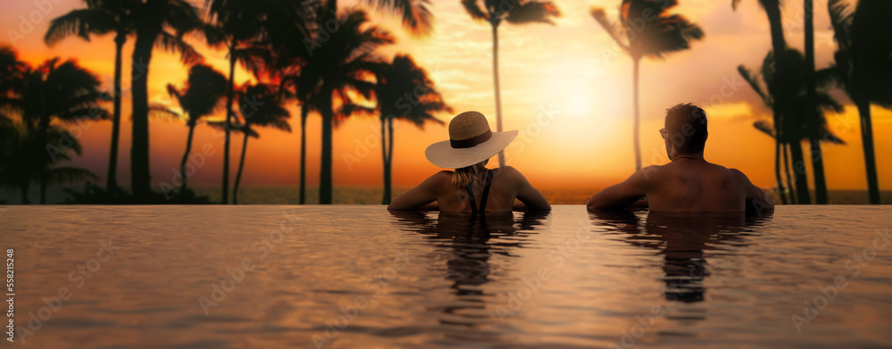 couple enjoying sunset from infinity pool at tropical island resort hotel. romantic beach getaway holiday. banner with copy space - obrazy, fototapety, plakaty 