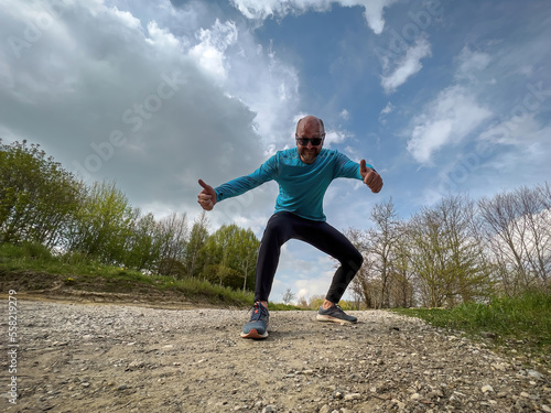 Happy running Sport man with blue shirt in free Spring nature  © Wolfgang Hauke