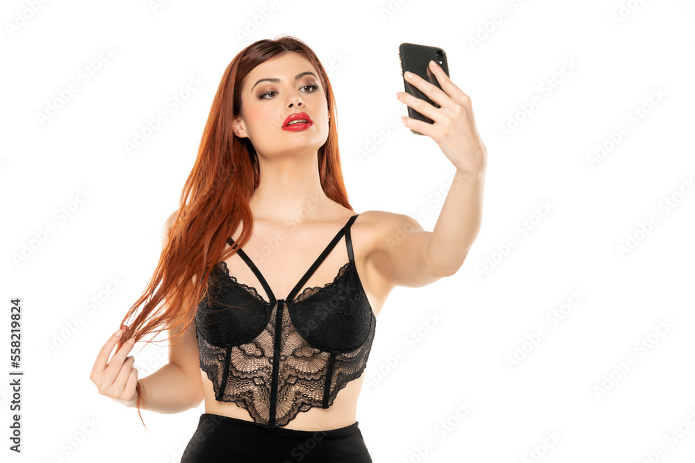 Portrait of attractive credhead glamorous wavy-haired woman using device gadget isolated over white background Portrait of attractive credhead glamorous wavy-haired woman using device gadget isolated over white background