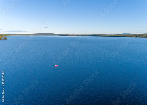 Aerial View of a lonely kayak in the middle of a Scandinavian Lake in Swedish Lappland, Travel Adventure