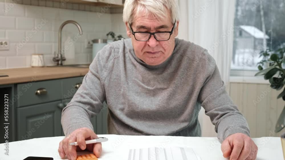 Senior Man Checking Calculating Personal Finance at Home, Feeling Stress from Money Problem. Concerned Elderly Male get Official Bank Notification, Financial Bill, Unpaid Debt or Tax and Feel Worried Senior Man Checking Calculating Personal Finance at Home, Feeling Stress from Money Problem. Concerned Elderly Male get Official Bank Notification, Financial Bill, Unpaid Debt or Tax and Feel Worried