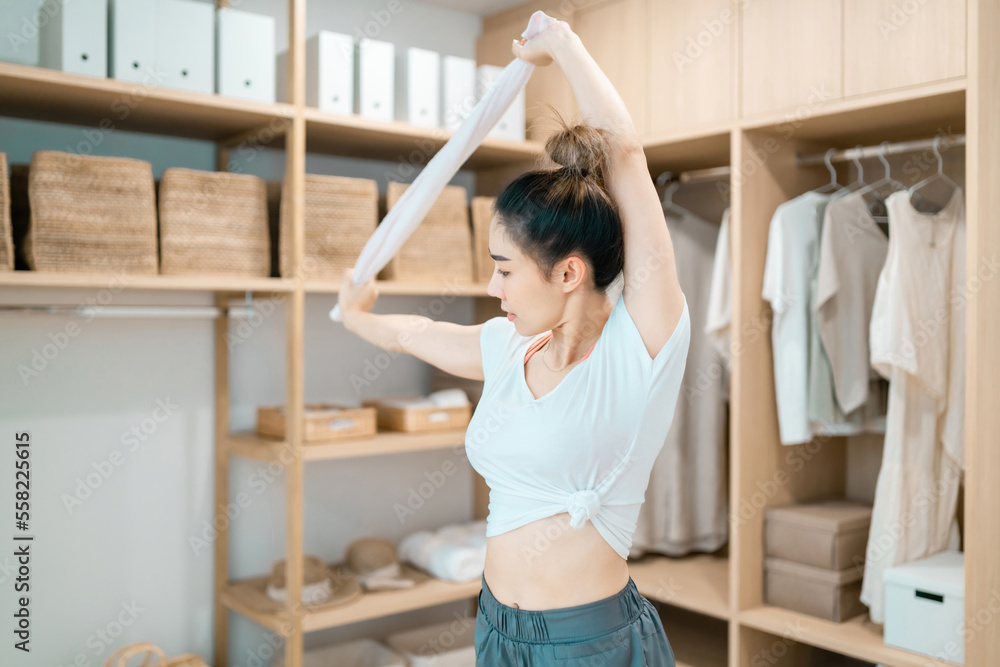 beautiful woman stretching body using cloth in dressing room. motivated woman stretching exercising holding towel with healthy concept. pretty woman balance body holding cloth relax control breathing beautiful woman stretching body using cloth in dressing room. motivated woman stretching exercising holding towel with healthy concept. pretty woman balance body holding cloth relax control breathing