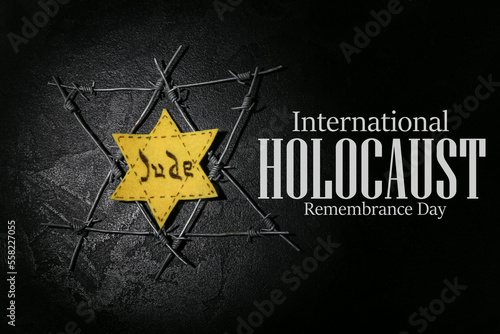 David star and barbed wire on dark background. International Holocaust Remembrance Day photo
