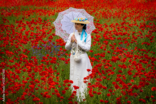 Woman in 19th century dress in a field of poppies