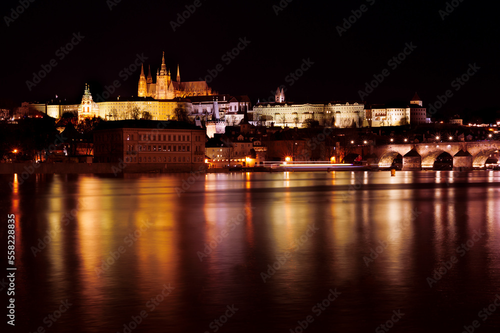 PRAGUE - December 29, 2022: Panorama of Prague Castle,St. Vitus cathedral and Charles Bridge at night.