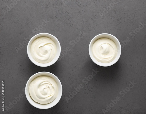 bowl of tasty mayonnaise on wooden background