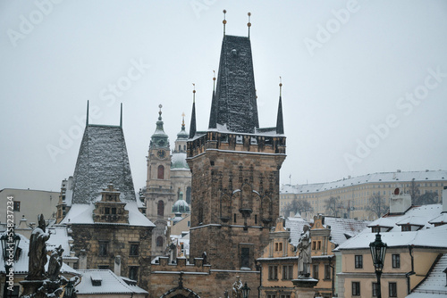 View of the Charles Bridge and the Malostranska tower on a winter day. Prague Czechia © Tomas Bazant