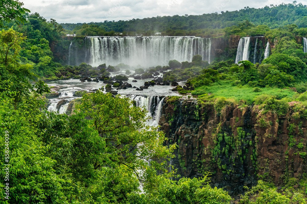 Iguazu Falls seen from the Brazilian side with tousist boat on small lake