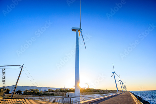 冬の響灘の風車と夕日　響灘北緑地公園　福岡県北九州市　Hibikinada windmill and sunset in winter. Hibikinada North Park. Fukuoka Prefecture, Kitakyushu City. photo