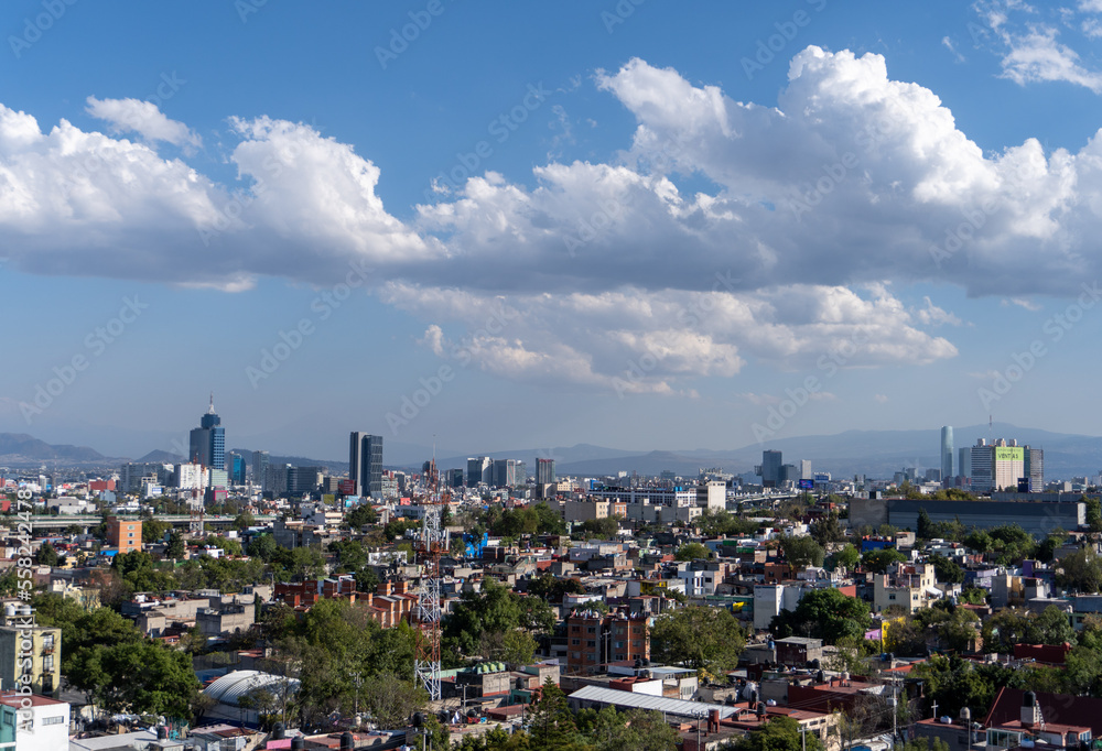 Aerial view of Mexico City, Mexico, on a sunny afternoon with beautiful sky.