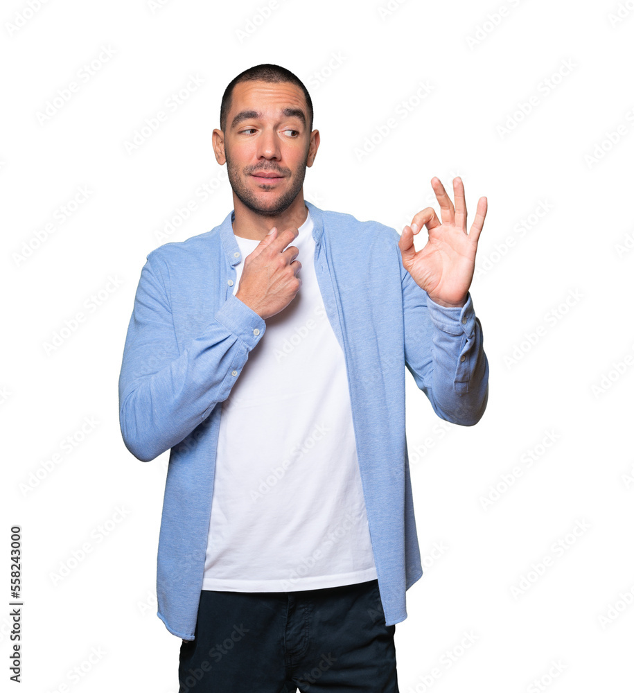 Worried young man doubting and making a gesture of approval Worried young man doubting and making a gesture of approval