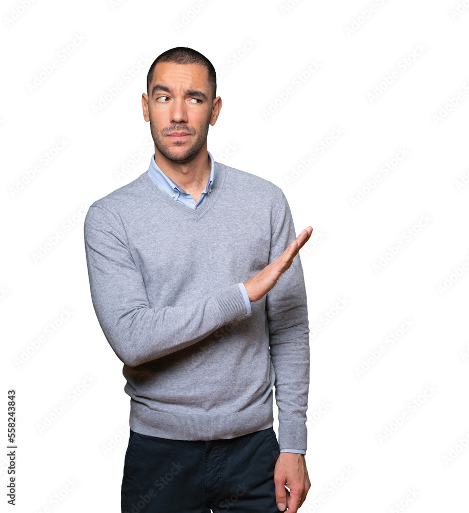 Doubtful young man doing a gesture of keep calm Doubtful young man doing a gesture of keep calm