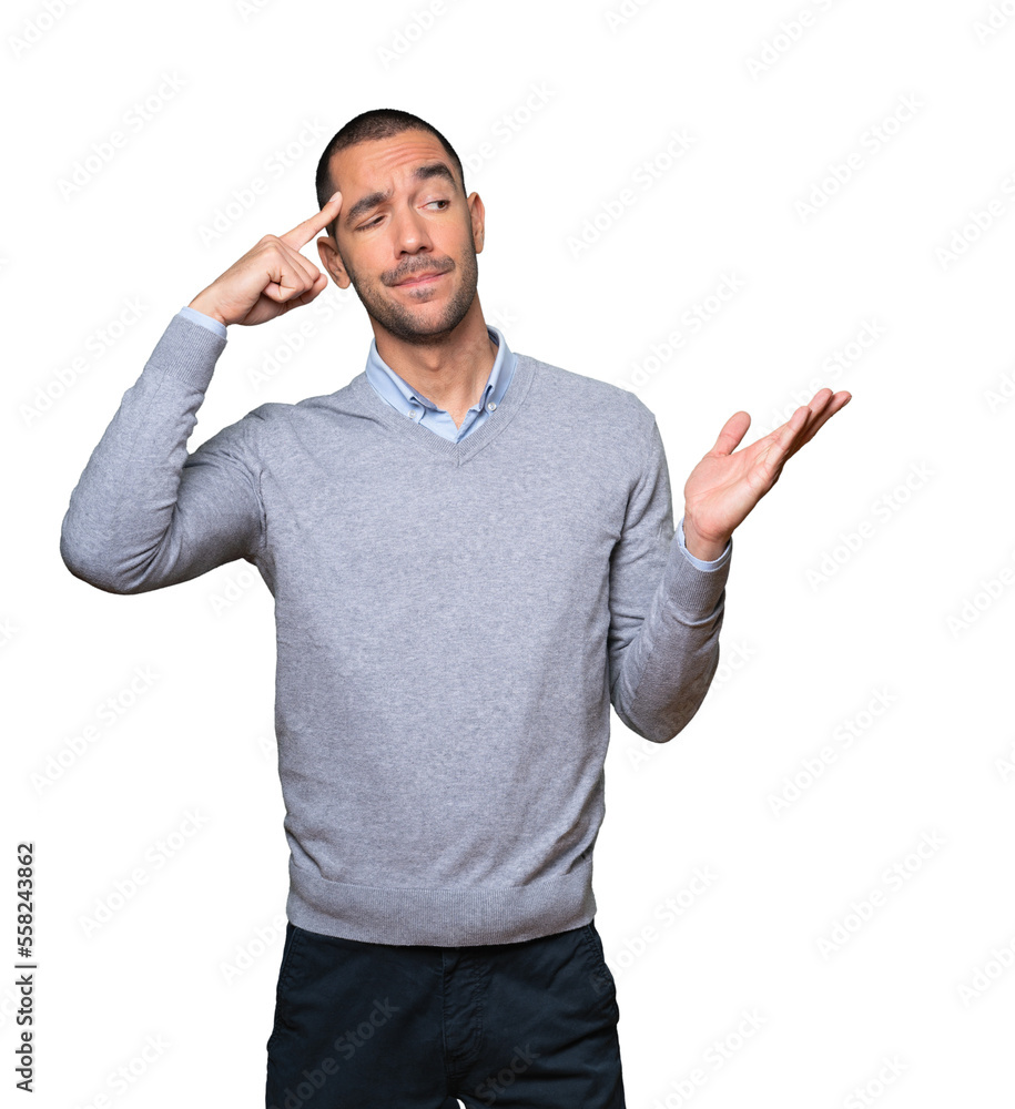 Serious young man doing a gesture of concentration Serious young man doing a gesture of concentration