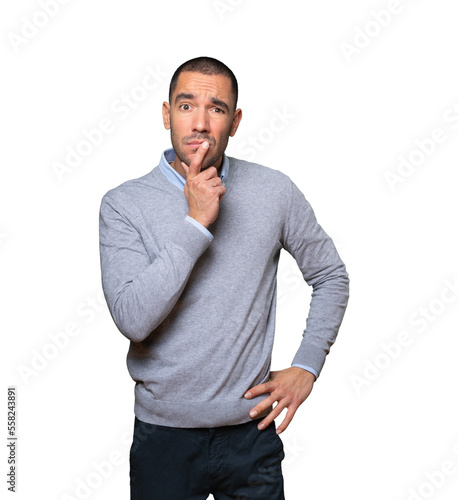 Concentrated young man making a gesture of distrust