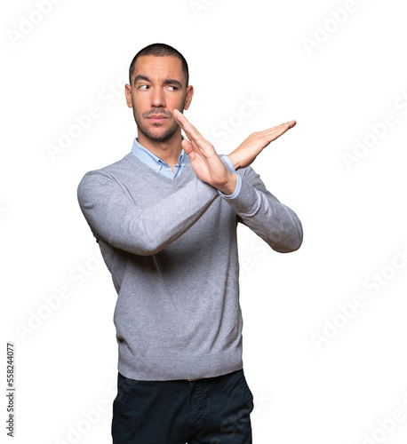 Young man making a gesture of not crossing with the arms photo