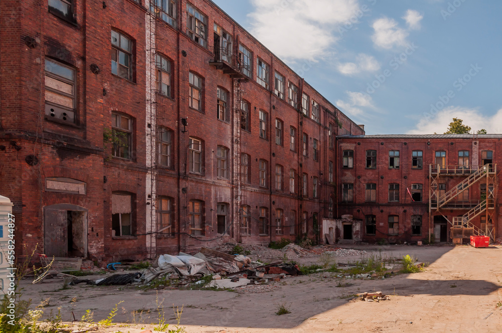 Old abandoned haunted red brick factory of stockings, pantyhose and socks in Central Europe, Poland