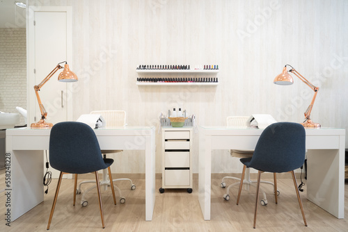 Manicure area. Manicure tables with lamps and cozy chairs in the barbershop. Concept of interior design for hairdressers and nail artists. High quality photo