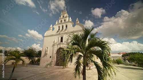 Time lapse of the Apostle Church Parroquia de Santiago Apostol with a blue sky in Merida, Yucatan, Mexico photo