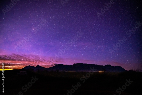 Sunlight and Car Lights Below Night Sky