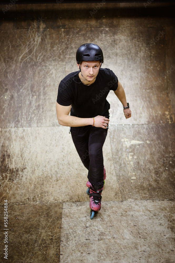 High angle view of young roller looking at camera while training on ramp in skate park High angle view of young roller looking at camera while training on ramp in skate park
