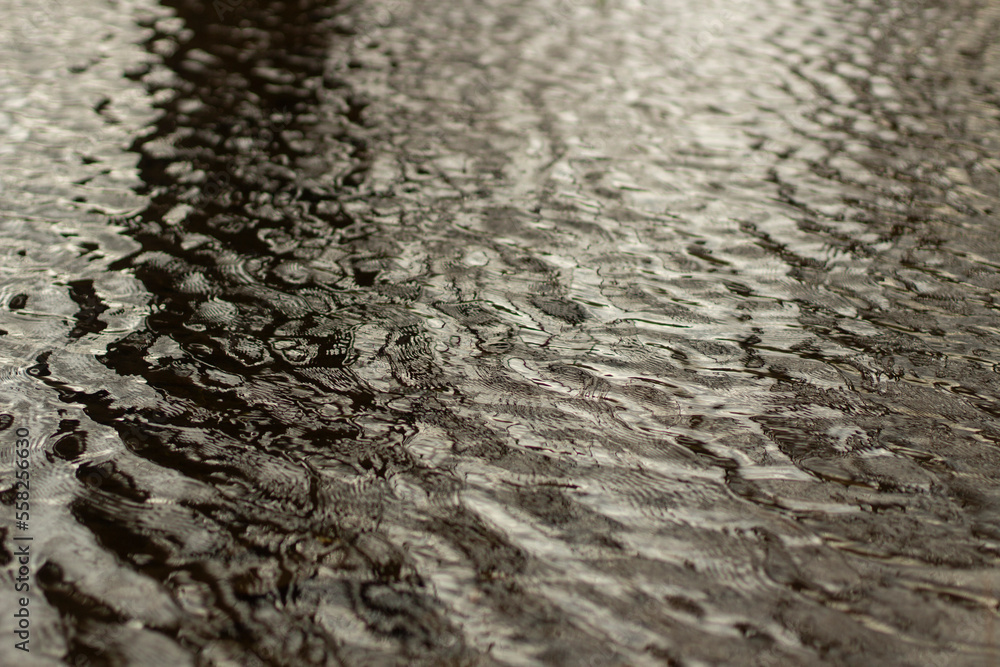 Obraz premium Waves on water. Wind on surface of water. Reflection in puddle.