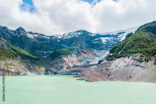 lake landscape with azure water surrounded by mountains and glaciers