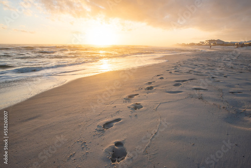 Footsteps on beach at sunsert
