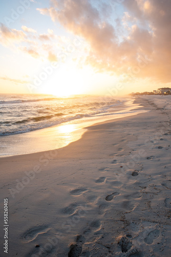 Footsteps on beach at sunset