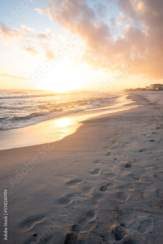 Footsteps on beach at sunset