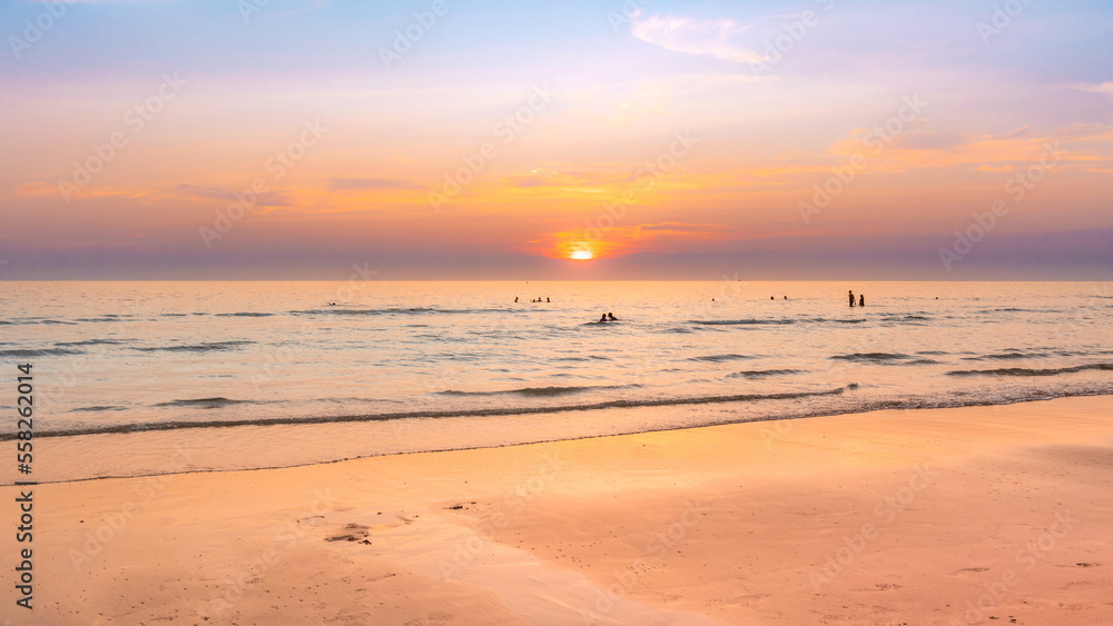 Beautiful sunset sky with calmness sea and warming ligh on the beach