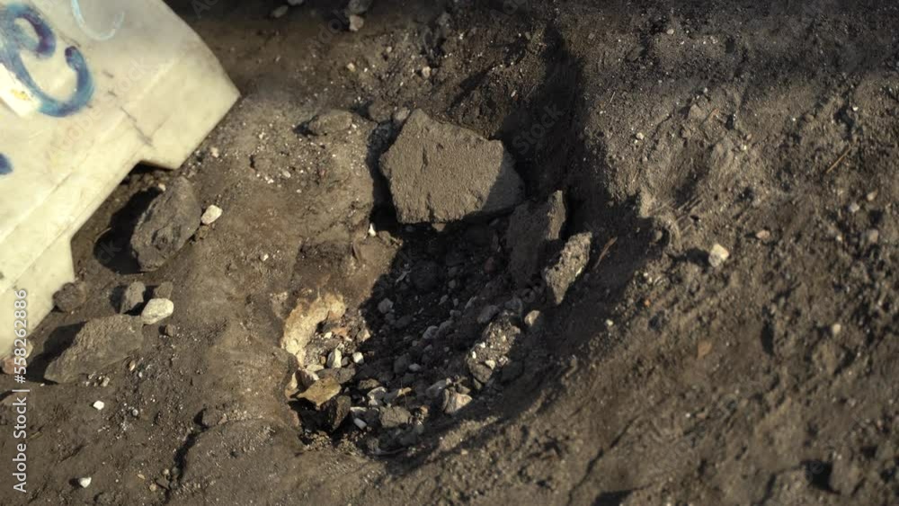 Consequences of rocket attack on the center of Ukraine. Funnel from a drone explosion. Attack of Iranian Shahed 136 drones on Kyiv. Damaged residential building. Broken windows and holes from debris. 